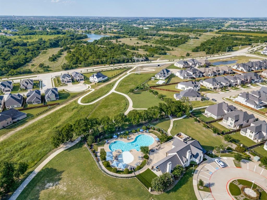 2721 Old Shire Path Road Prosper, TX 75078 - Photo 37 of 39 Community development featuring residential properties, recreational building, and two swimming pools surrounded by green space with walking paths
