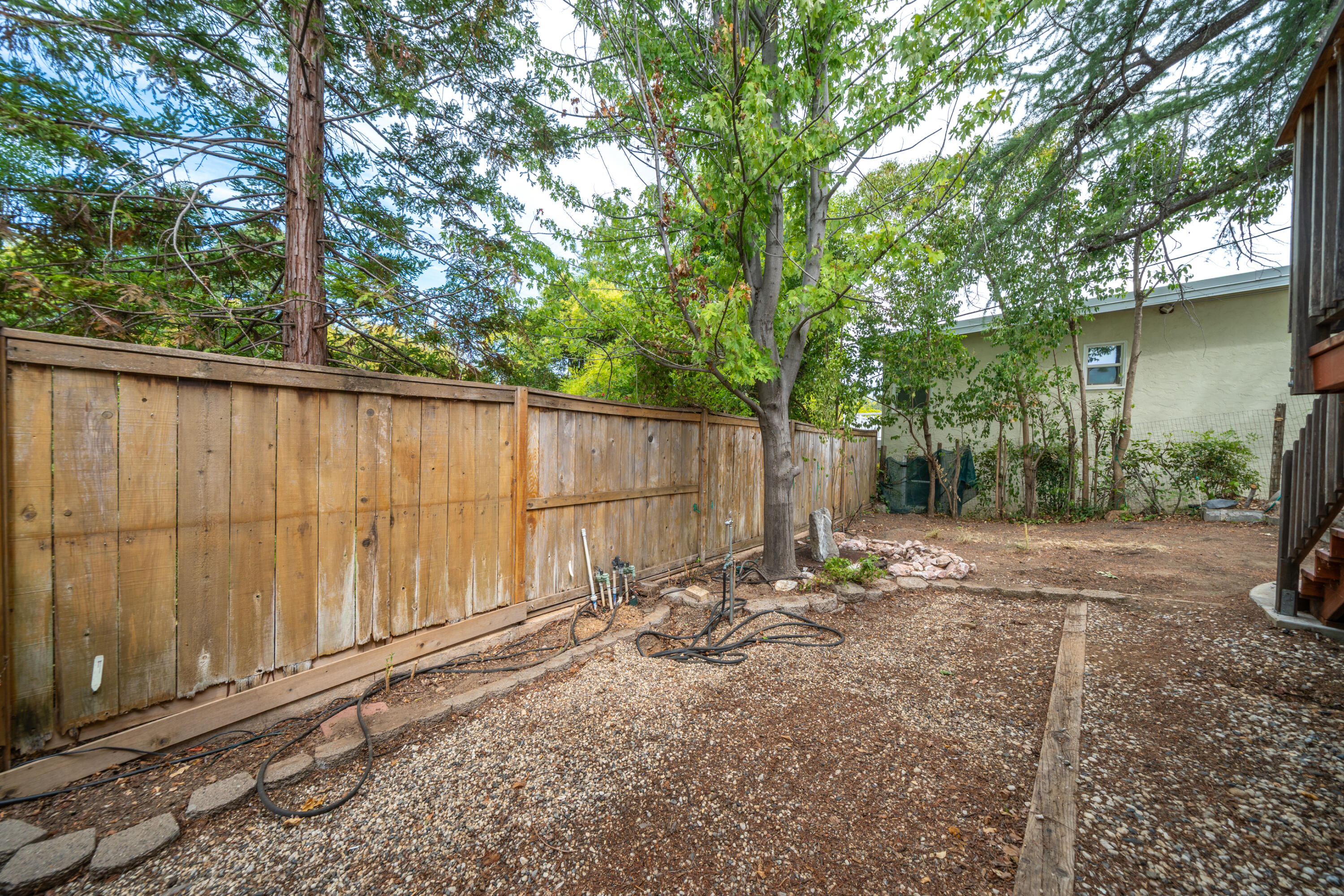 3500 Longview Avenue Redding, CA 96001 - Photo 20 of 25 a backyard of a house with table and chairs a barbeque and a large tree