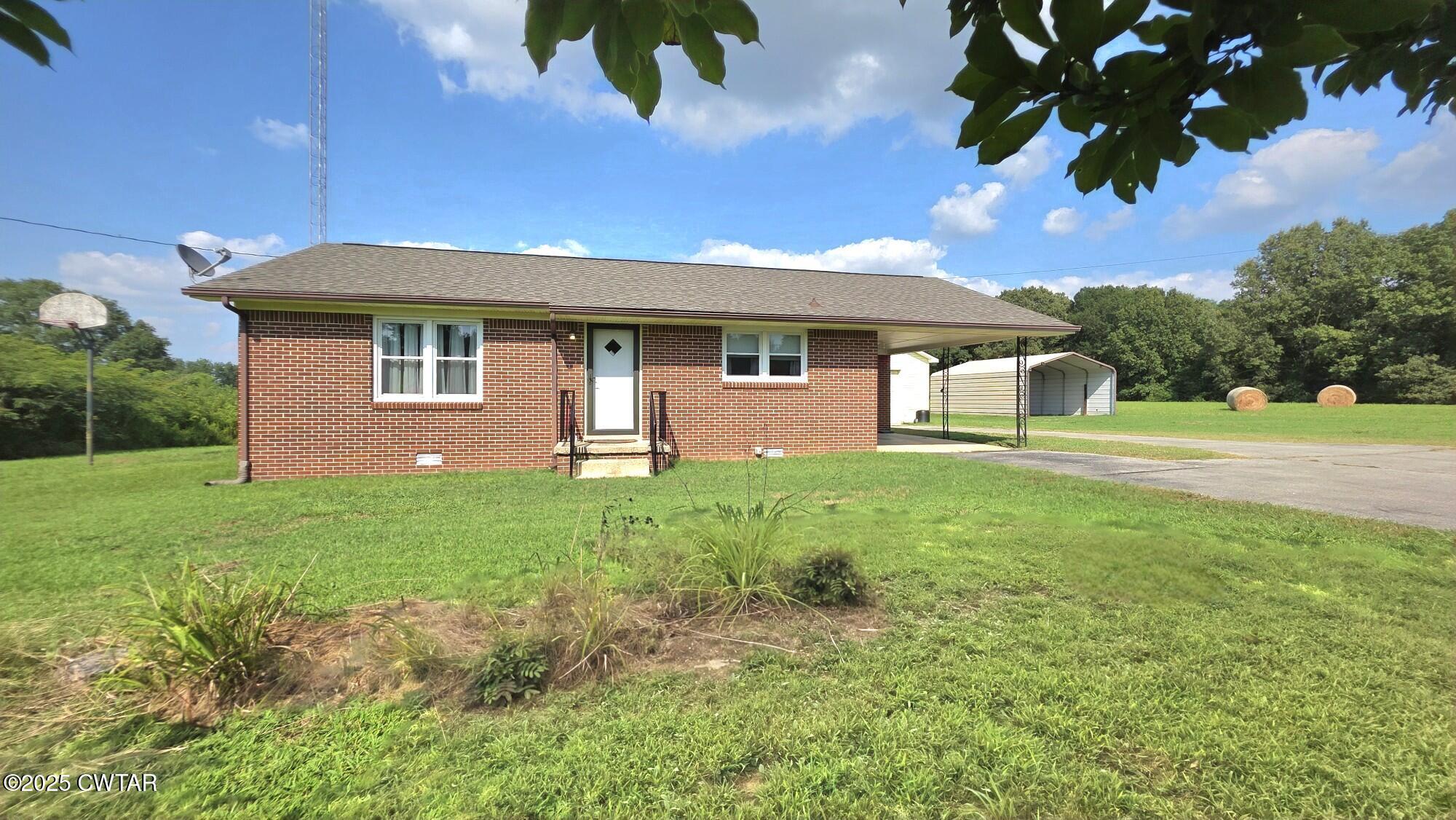 811 Gibson Road Trenton, TN 38382 - Photo 12 of 23 a front view of a house with a garden