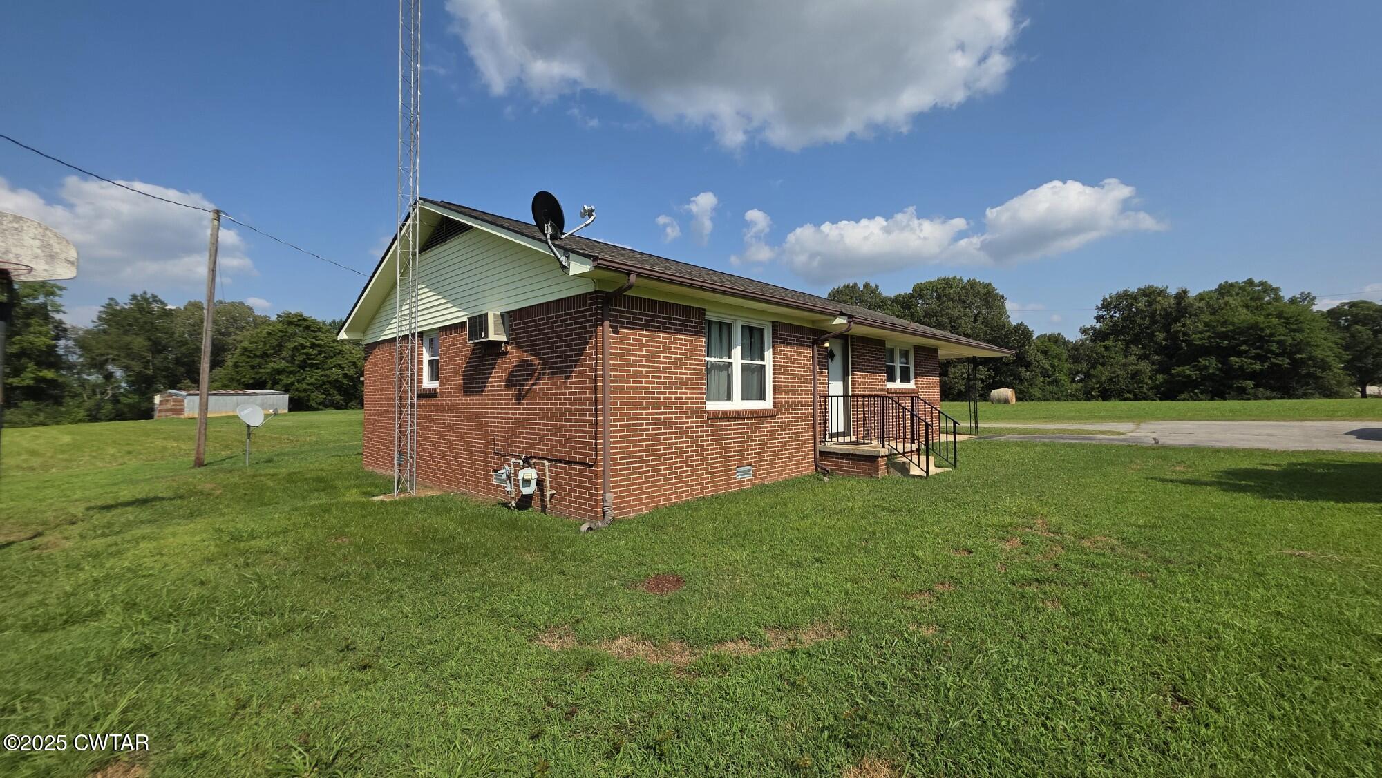 811 Gibson Road Trenton, TN 38382 - Photo 18 of 23 a front view of a house with garden