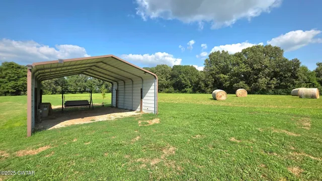 a view of a house with a backyard and porch