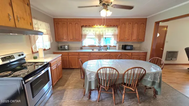 a kitchen with stainless steel appliances granite countertop a stove a sink dishwasher and cabinets