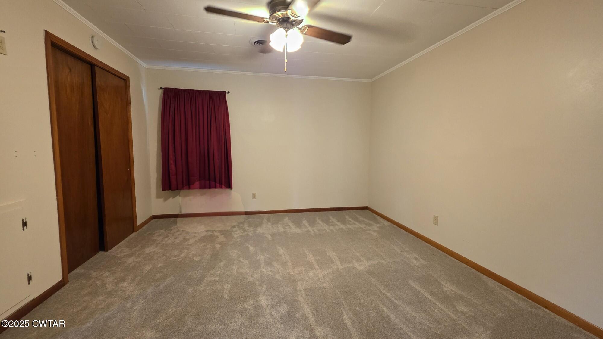 811 Gibson Road Trenton, TN 38382 - Photo 7 of 23 a view of an empty room with a ceiling fan