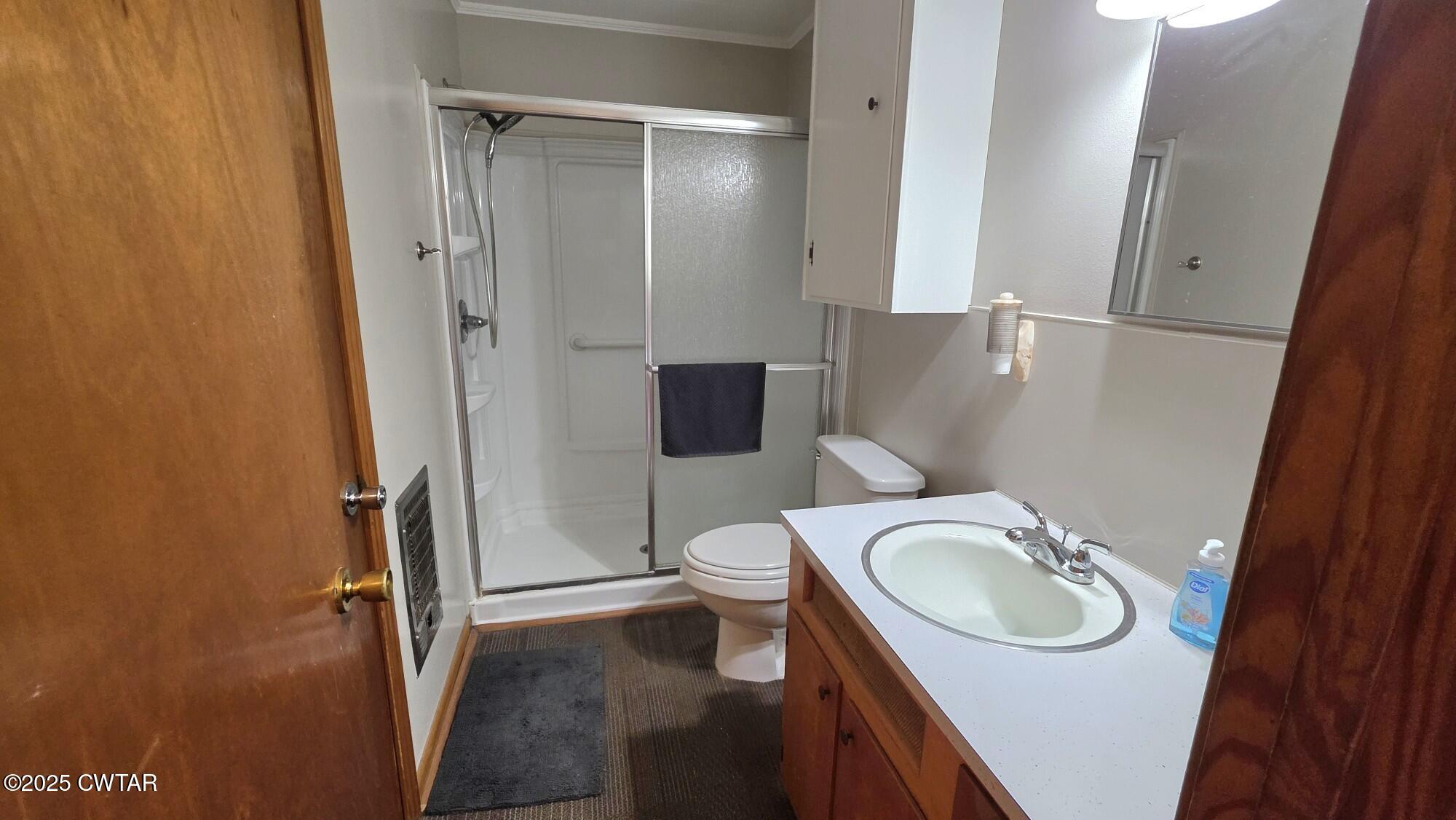 811 Gibson Road Trenton, TN 38382 - Photo 9 of 23 a bathroom with a sink a toilet and a shower