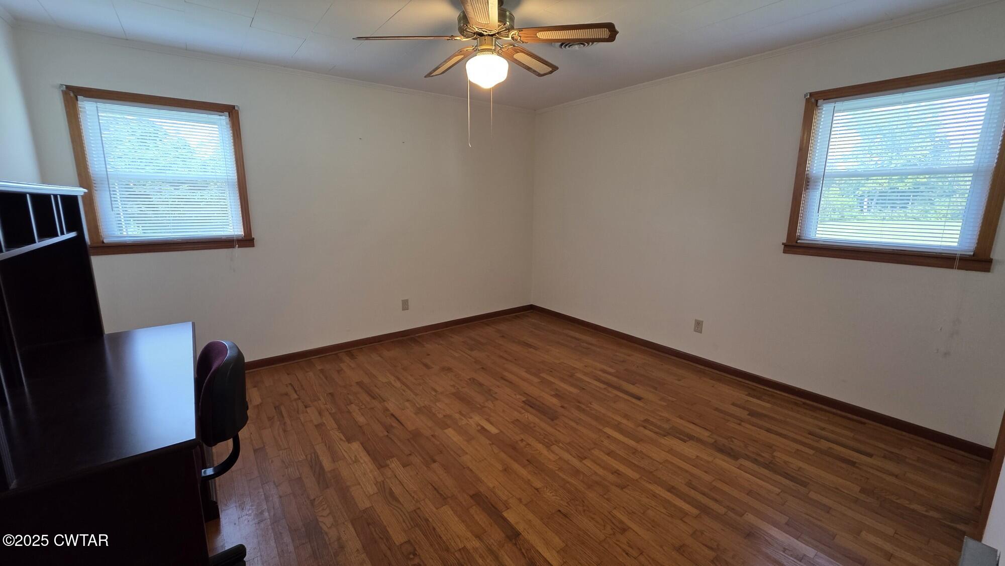 811 Gibson Road Trenton, TN 38382 - Photo 10 of 23 wooden floor in an empty room with a window