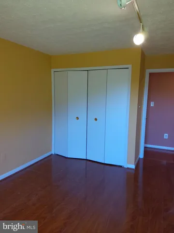an empty room with wooden floor