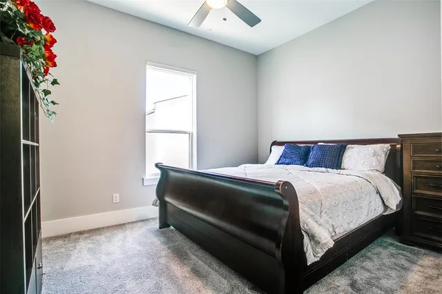 a bed sitting in a bedroom next to a window