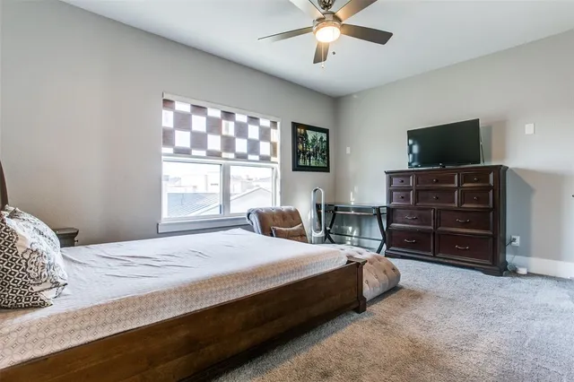 a bedroom with a bed and a television