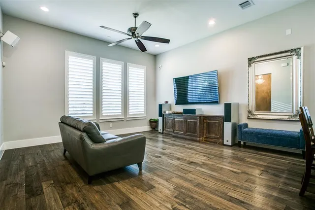 a living room with fireplace furniture and two window