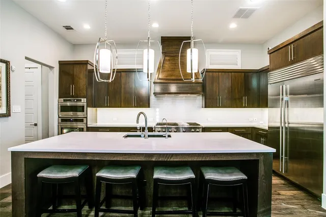 a kitchen with a sink cabinets and refrigerator