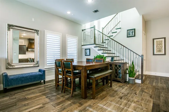 a dining room with furniture entryway and wooden floor