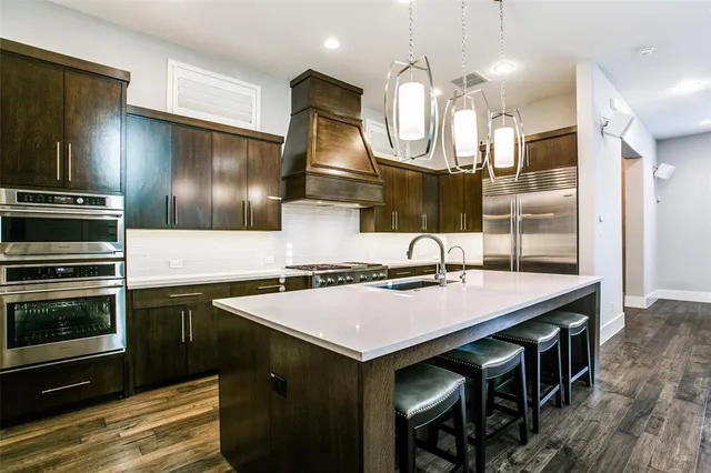 a kitchen with a stove a refrigerator and a microwave