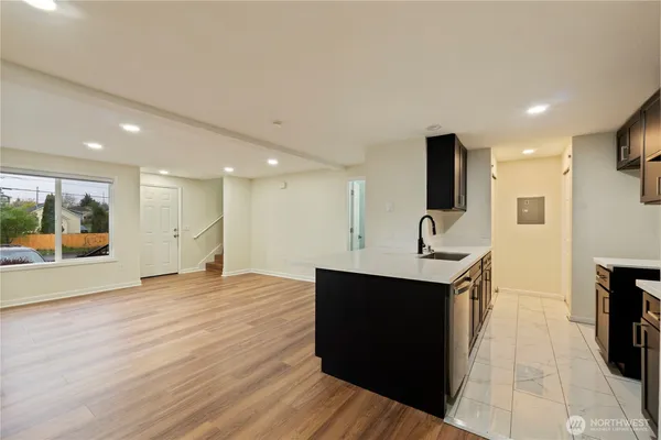 a view of kitchen with stainless steel appliances granite countertop a sink and a stove