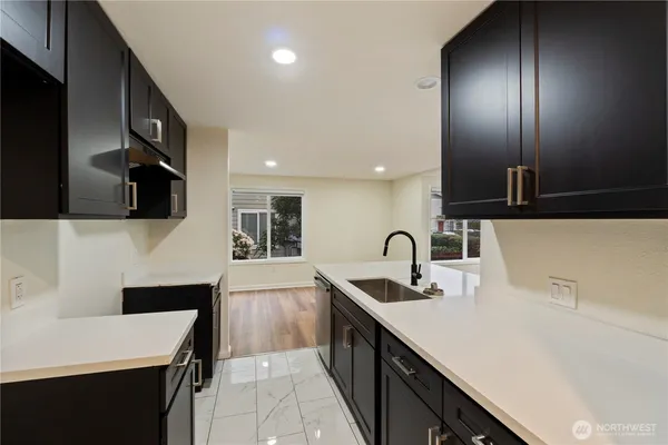 a kitchen with a sink and a refrigerator