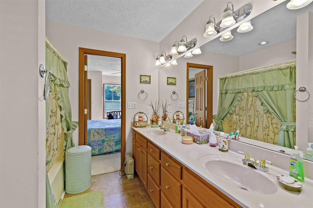 1150 Tyler Road Lexington, TN 38351 - Photo 17 of 24 a bathroom with a double vanity sink and a mirror