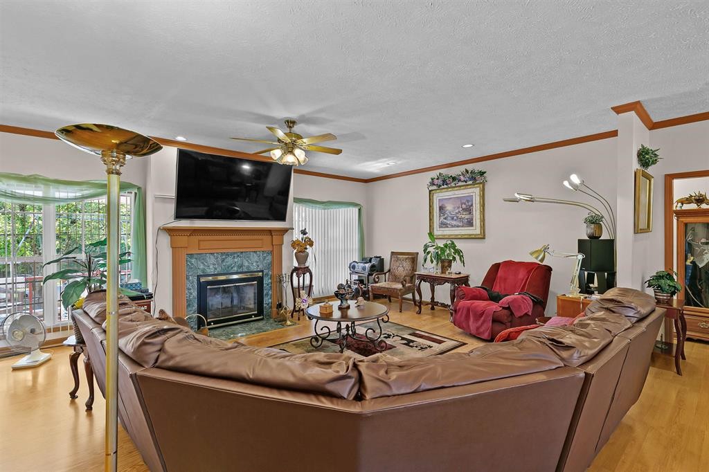 1150 Tyler Road Lexington, TN 38351 - Photo 8 of 24 a living room with furniture a fireplace and a flat screen tv