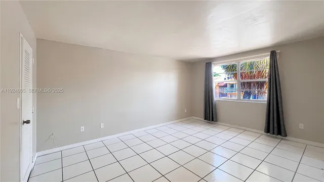a view of an empty room and bathroom