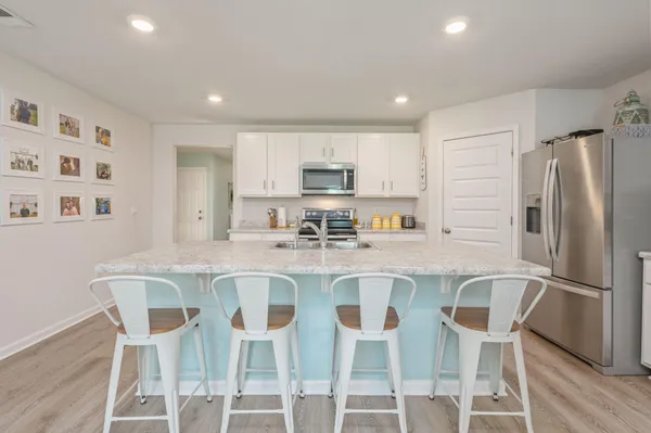 a kitchen with granite countertop a sink and a counter top space