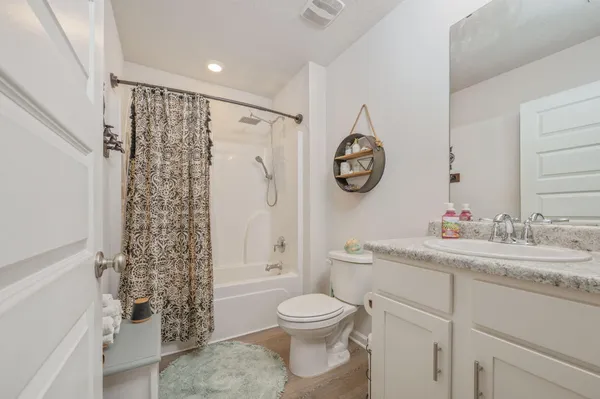 a bathroom with a shower a bath tub and a shower