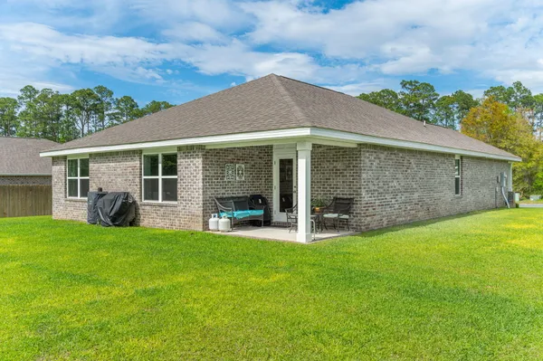 a front view of house with a garden