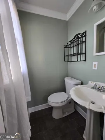 a white toilet sitting next to a small sink