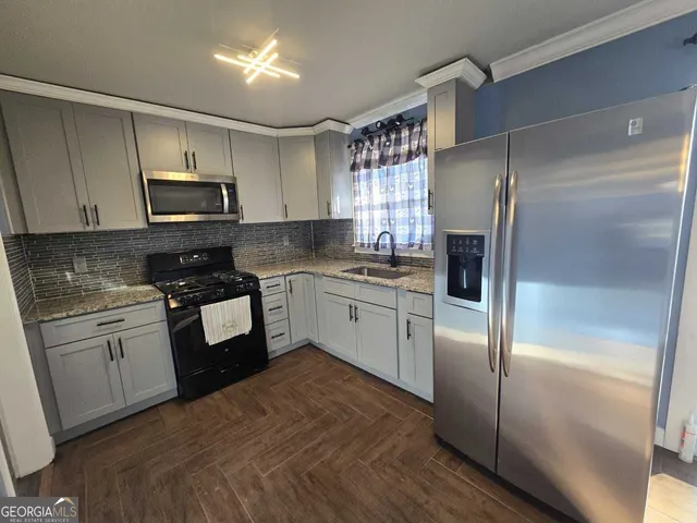 a kitchen with a refrigerator stove and microwave
