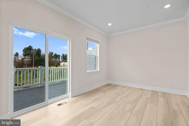 a view of a room with wooden floor and a window
