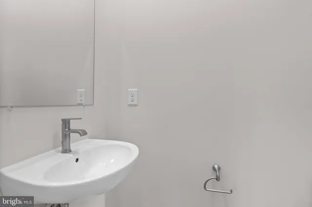a bathroom with a sink and mirror