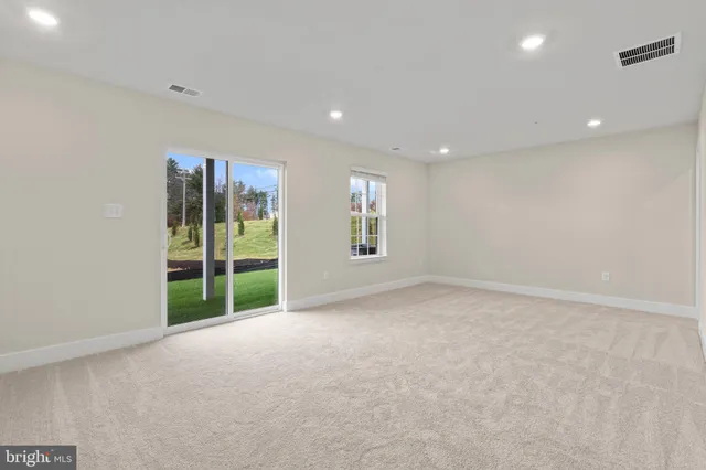 a view of an empty room with glass door