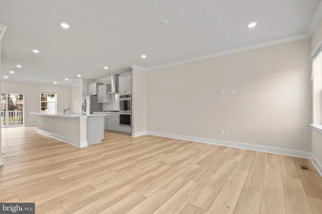 a view of kitchen with kitchen island and stainless steel appliances