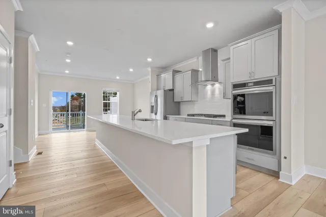 a large kitchen with cabinets and stainless steel appliances