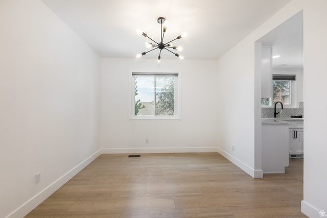 11906 Woodridge Road Sandy, UT 84094 - Photo 14 of 35 Bright dining room featuring wood-finish flooring and a contemporary sputnik chandelier