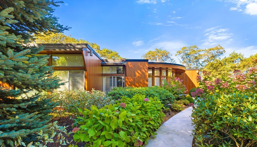 17 Deer Run Wayland, MA 01778 - Photo 2 of 42 a view of a multi story yard with plants and large trees