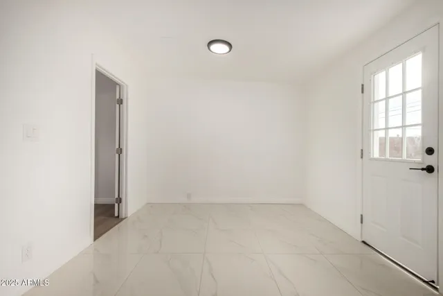 an empty room with windows and closet