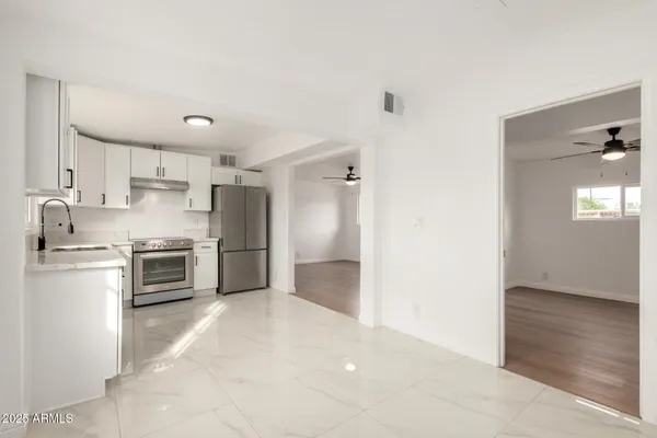 a kitchen with a refrigerator and a stove