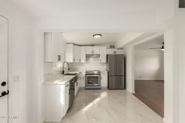 a kitchen with a refrigerator stove and sink