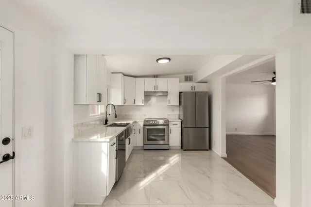 a kitchen with a refrigerator stove and sink