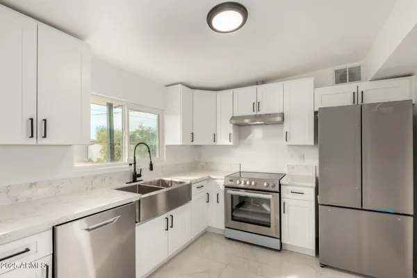 a kitchen with a sink stove and refrigerator