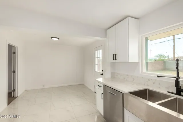 a kitchen with a sink cabinets and window