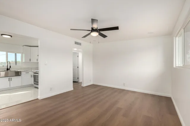 wooden floor in an empty room with a window