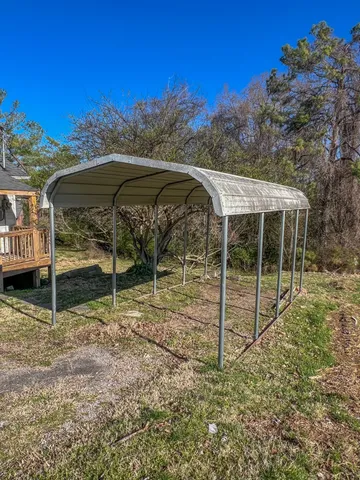 a view of a wooden house with a yard