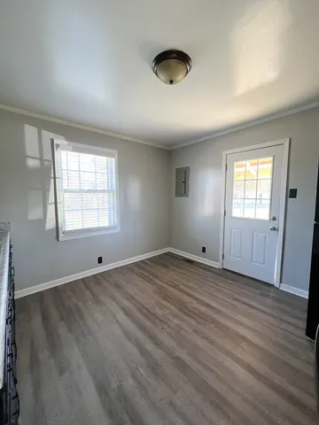 wooden floor in an empty room with a window