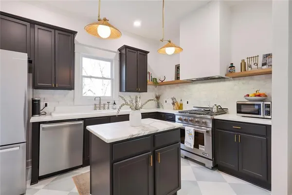 a kitchen with a sink stove and cabinets