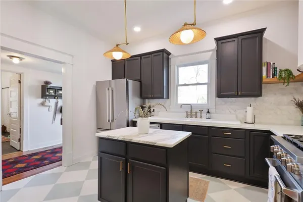 a kitchen with a sink appliances and cabinets