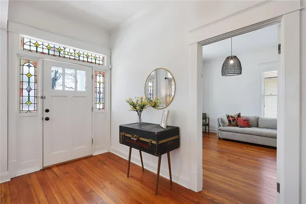 a living room with furniture and a wooden floor