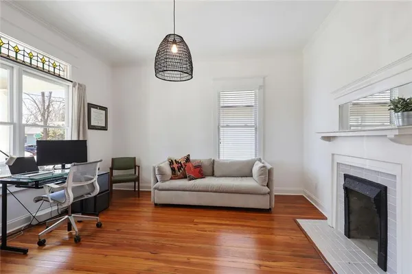 a living room with furniture fireplace and window
