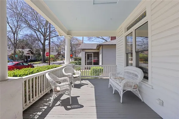 a view of a chair and tables in the balcony