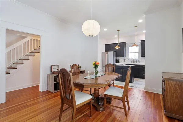 a view of a dining room with furniture and wooden floor
