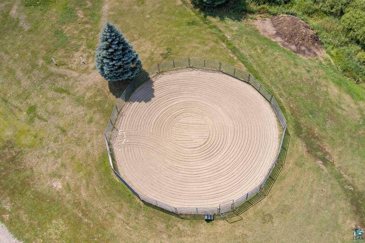 3201 Wilderness Road Makinen, MN 55763 - Photo 36 of 44 Circular fenced arena with sand footing, surrounded by a grassy expanse