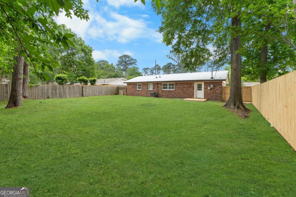 320 West Whatley Street Pooler, GA 31322 - Photo 30 of 34 a view of a house with a yard and sitting area